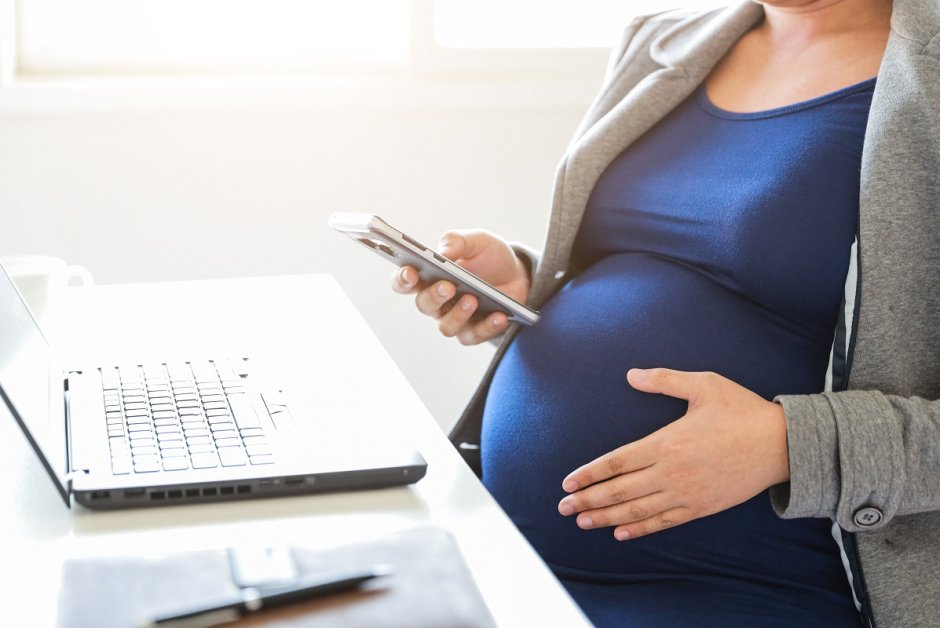 pregnant woman is working on computer laptop and mobile phone, business